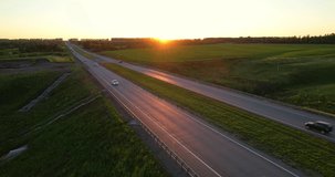 Highway on the background of sunset. Traffic on the highway. Trucks with a semi-trailer are moving in the same direction. High quality 4k footage.