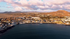 Aerial panning clip of the town, beaches and harbour of Corralejo Fuerteventura 