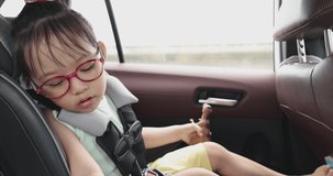 4K Video slow motion Asian kid in car seat on the car driving. Video concept for family traveling and safety on car.