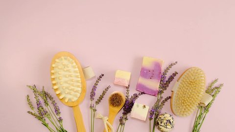 Lavender bath soap and truffles.spa set with lavender extract and natural bristle brushes and lavender flowers on a pink background.Lavender organic body cosmetics.Soap bars and truffles for the body
