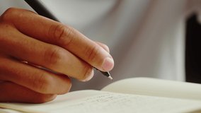 African American man writing close-up. Teenager making notes, studying, doing homework. Home education concept. - Powered by Shutterstock - Get 15% off with code: PIKWIZARD15