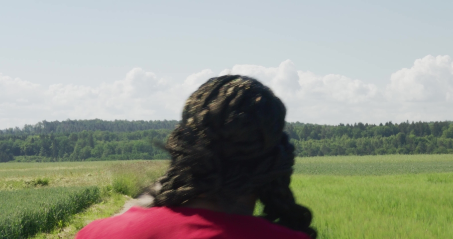 Samson walking away from screen into distance along old road in green pastures, Biblical character with long dreads, Israelite warrior and judge, black male in old testament, Christian Royalty-Free Stock Footage #1091343575