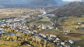 Aerial Drone Over the Vineyards and a small Valley with a Church in the center in Autumn in South Tyrol.