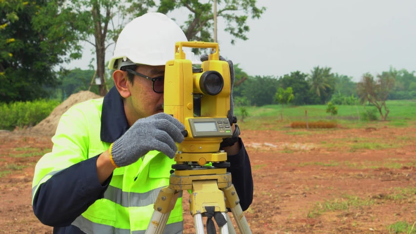 Surveyor engineer with equipment theodolite or total positioning station on the construction site.  Royalty-Free Stock Footage #1091349465