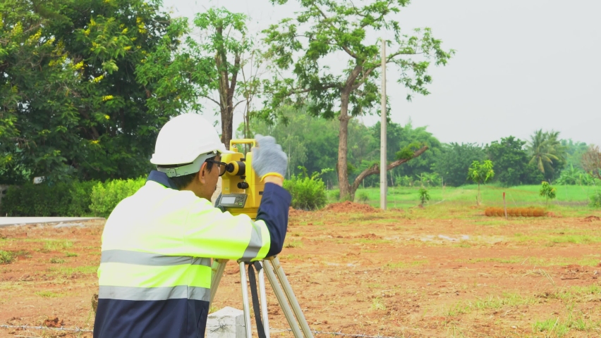 Surveyor engineer with equipment theodolite or total positioning station on the construction site.  Royalty-Free Stock Footage #1091349469