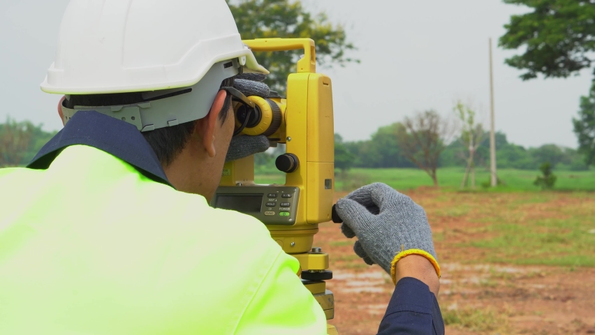 Surveyor engineer with equipment theodolite or total positioning station on the construction site.  Royalty-Free Stock Footage #1091349471