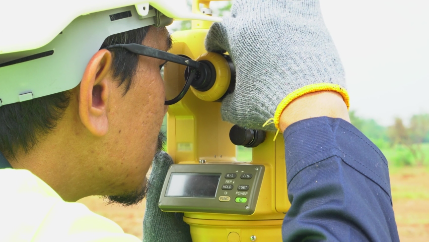 Surveyor engineer with equipment theodolite or total positioning station on the construction site.  Royalty-Free Stock Footage #1091349473