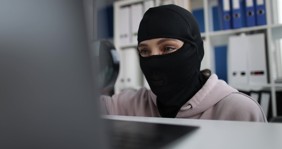 A woman in mask looks into laptop through magnifying glass Royalty-Free Stock Footage #1091357013