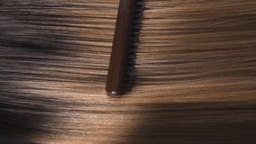 Brushing hair. Beautiful healthy long smooth flowing brown hair close-up texture. Dyed straight shiny hair background, coloring, extensions, cure, treatment concept. Haircare. Slow motion - Powered by Shutterstock - Get 15% off with code: PIKWIZARD15
