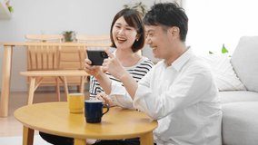 Men and women watching videos on smartphones in their rooms.