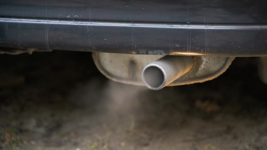 White smoke from the exhaust pipe of an unheated car. Close-up of car emissions. High quality 4k footage Royalty-Free Stock Footage #1091365011