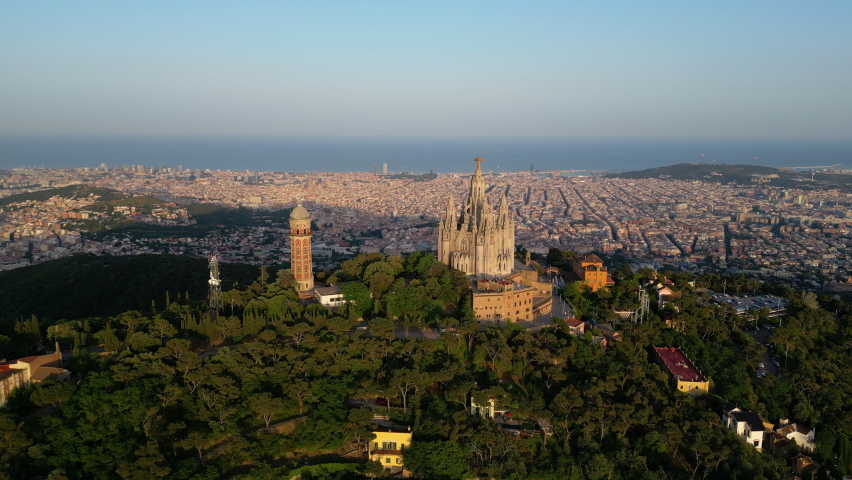 Aerial view of Barcelona skyline with Sagrat Cor temple during sunset, Catalonia, Spain | Shutterstock HD Video #1091368045