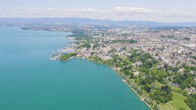 Inscription on video. Lausanne, Switzerland. Flight over the central part of the city. The coast of Lake Geneva. Glitch effect text, Aerial View