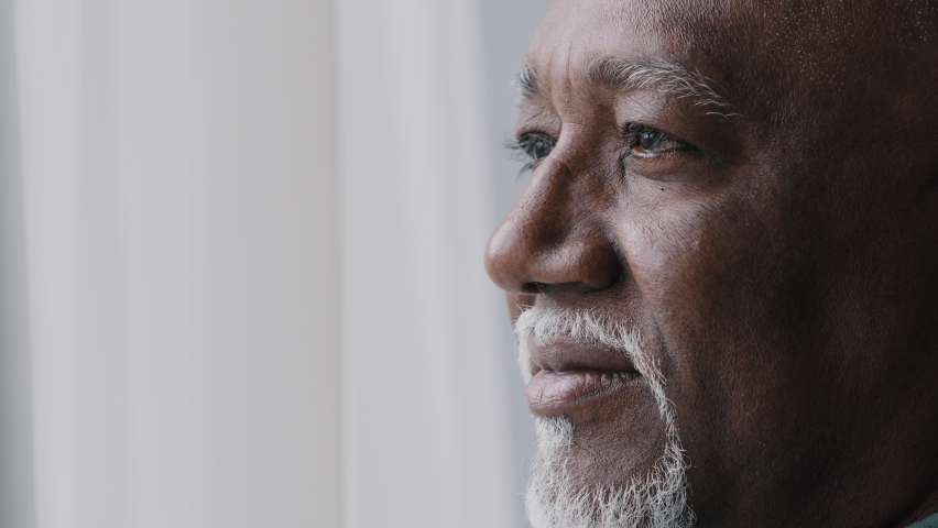 Close up pensive male old wrinkled face, 60s African bearded man deep in sad thoughts looking at window, elderly grandfather look away think about disability feel lonely. Nostalgia retired businessman Royalty-Free Stock Footage #1091374493