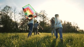 Happy family in park with dog run kite. Family picnic on green grass with pet. People play with kite in meadow in summer. Children with parents freedom and active lifestyle Family in nature dog play - Powered by Shutterstock - Get 15% off with code: PIKWIZARD15