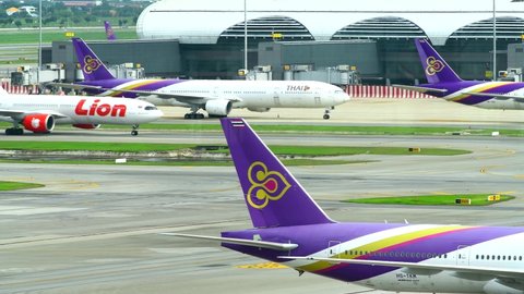 BANGKOK-JUNE 12, 2022: View docked away flights in Suvarnabhumi Airport. Suvarnabhumi Airport is one of two international airports serving Bangkok, Thailand.
