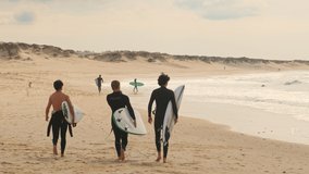 Unidentified surfers with surf board walk on the Baleal beach and watching other surfers catching waves. Baleal is a popular surfing spot in Portugal.  - Powered by Shutterstock - Get 15% off with code: PIKWIZARD15