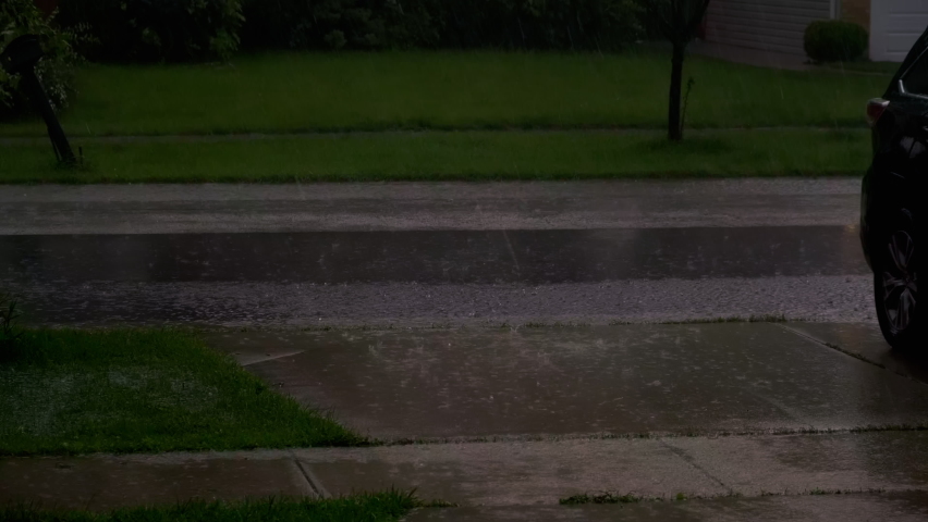 Heavy rain, with loud thunder and lightning, a suburban residential street. Close up view