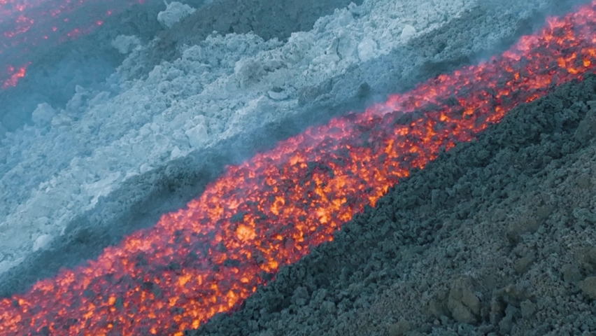 Drone shooting of the lava flow on the Etna volcano in Sicily. Flow of the month of June 2022. River of lava, effusive and ephemeral activity. Etna erupting in 2022. Opening at 1900 m.s.l.m. Royalty-Free Stock Footage #1091388523