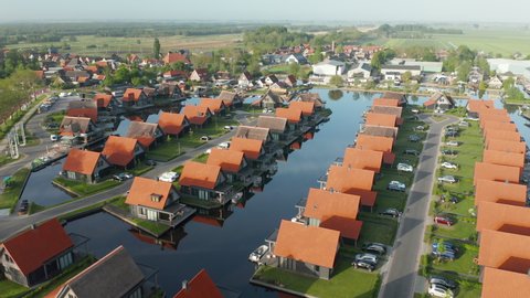 Panorama Of Polder And Luxxury Sustainable Holiday Homes In Netherlands. - aerial pullback