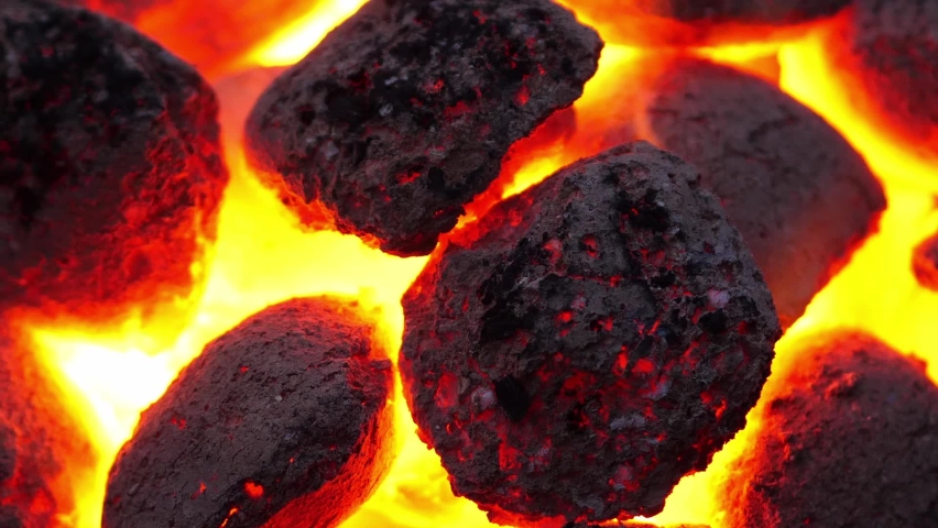 Glowing hot fire briquettes burning in barbeque braai, Close up, zoom out Royalty-Free Stock Footage #1091389979