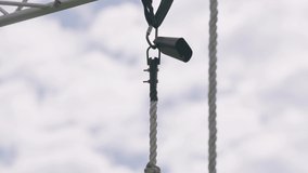 Rope climber rings cowbell at top of rope during military obstacle course training race close up slow motion 4k - Powered by Shutterstock - Get 15% off with code: PIKWIZARD15