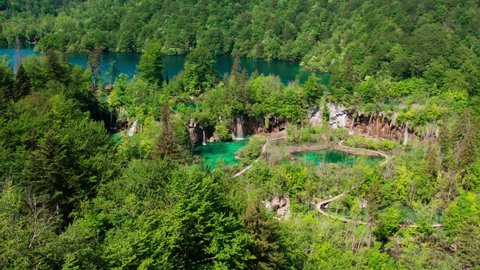 Aerial view of flowing waterfall in turquoise water lakes in Croatian national park. Summer leisure time