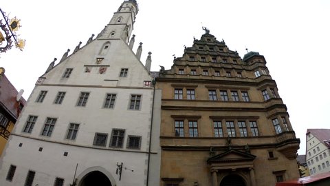 Rothenburg ob der Tauber, Germany, December 8, 2021: TILT SM The Market Square and Town Hall Tower, with its grand stairs, the Renaissance façade and surrounded by the romantic timber-frame buildings.