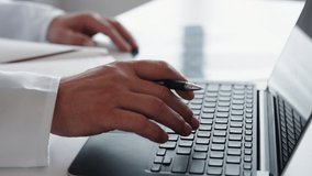 Electronic medical record. Online healthcare. Hospital EMR. Male doctor hands typing using laptop taking notes at light workplace. - Powered by Shutterstock - Get 15% off with code: PIKWIZARD15