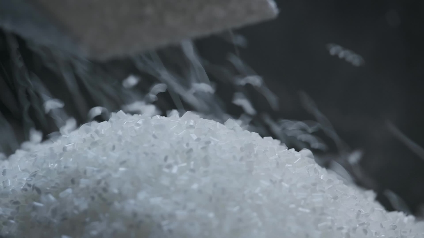 Polyethylene granules. Plastic resin. White plastic pellets. Raw material for plastic products. Grains pouring in a heap. Coloring concentrates and additives for plastics Royalty-Free Stock Footage #1091392401