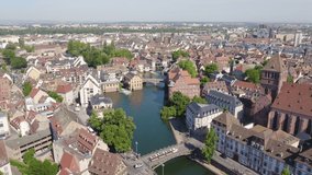 Inscription on video. Strasbourg, France. Historic City, Ill River. Arises from blue water, Aerial View, Departure of the camera