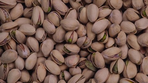 Rotating pistachios background top view close-up