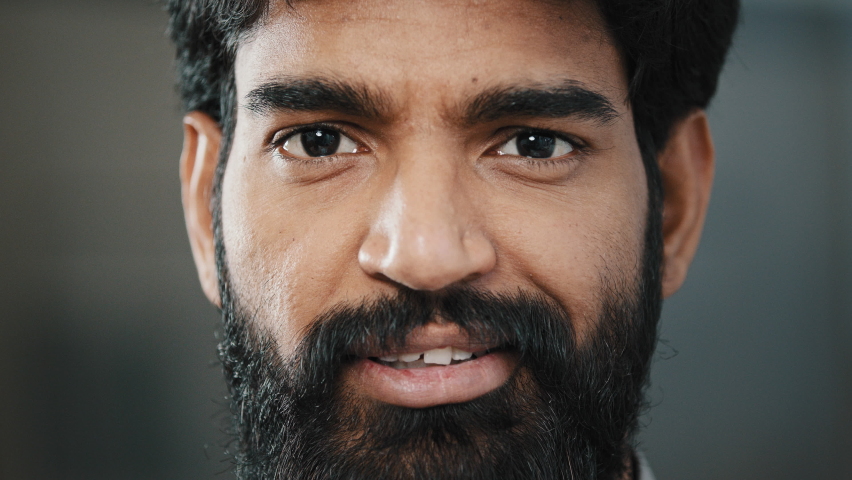 Close up portrait male bearded face adult brunet man with dark brown eyeballs looking at camera smiling hispanic indian positive young guy handsome intelligent person having good mood posing indoors Royalty-Free Stock Footage #1091400131