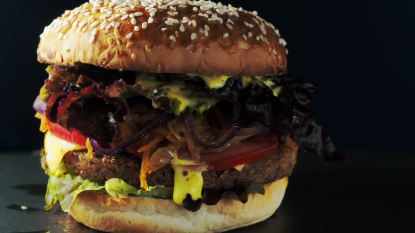 Vegan burger revolves on a slate plate. 4k Royalty-Free Stock Footage #1091405867