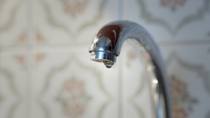 Stop water jet from faucet. water overlapping, ran out. jet stops running from tap, slow motion water drops dripping after water stops. dripping drop a faucet spout, close-up | Shutterstock HD Video #1091410565