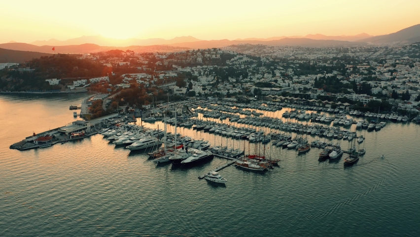 Aerial drone view of sea, harbor, boats and city architecture. Majestic view of resort town of Bodrum in Turkey. Royalty-Free Stock Footage #1091410801