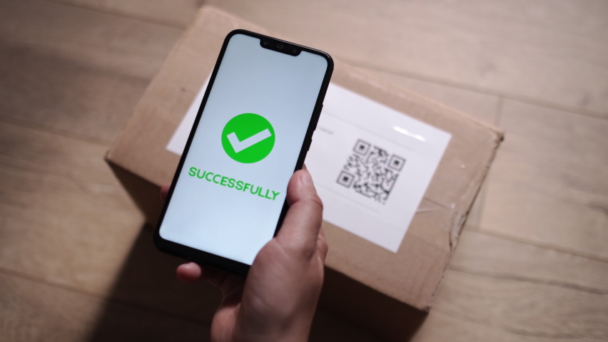 Scanning QR Code on Cardboard Parcel Using Cell Phone at Apartment. Postal Parcel Barcode Scanning Using Smartphone Application for Reading QR Barcode. QR Code Reader with Success Approval. Close Up.  | Shutterstock HD Video #1091412585