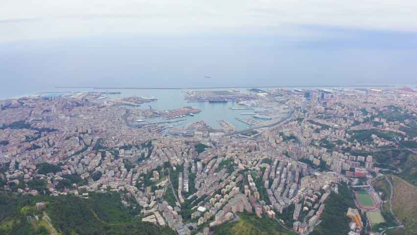 Inscription on video. Genoa, Italy. Central part of the city, aerial view. Ships in the port. Lightning strikes the letters, Aerial View