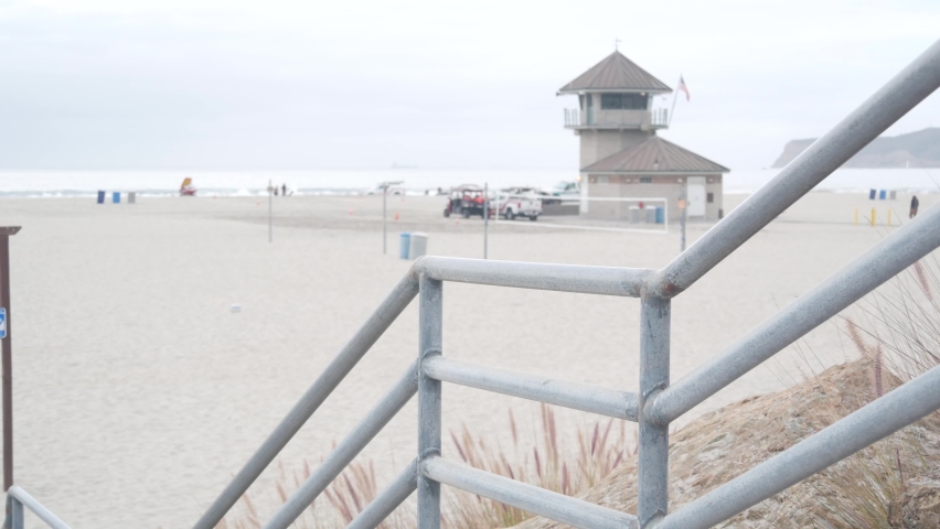Lifeguard stand or life guard tower hut, surfing safety on California beach, USA. Rescue station, coast lifesavers wachtower or house, Coronado ocean beach, San Diego. Beach access stairs or steps.