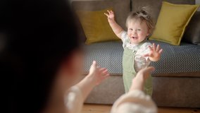 Little feet walking floor. Baby learning walk home. Baby first steps. Affectionate family cute adorable funny little kid boy embrace kiss young mom, happy loving mother and small child - Powered by Shutterstock - Get 15% off with code: PIKWIZARD15