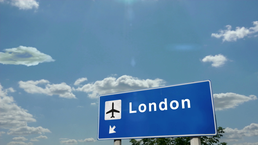 Jet plane landing in London, England, UK. City arrival with airport direction sign. Travel, business, tourism and airplane transport concept.