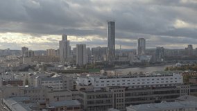 A beautiful big city from a bird's-eye view.Stock footage. The bright city of Yekaterinburg, the city center with high-rise buildings, a river and large houses.