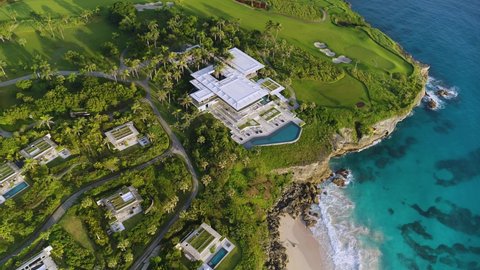 Luxury hotel and sandy beach on the Caribbean coast. Golf courses on a green peninsula in the blue ocean. Summer evening on a tropical beach. Amanera, Santo Domingo, Dominican Republic - May 05, 2022.