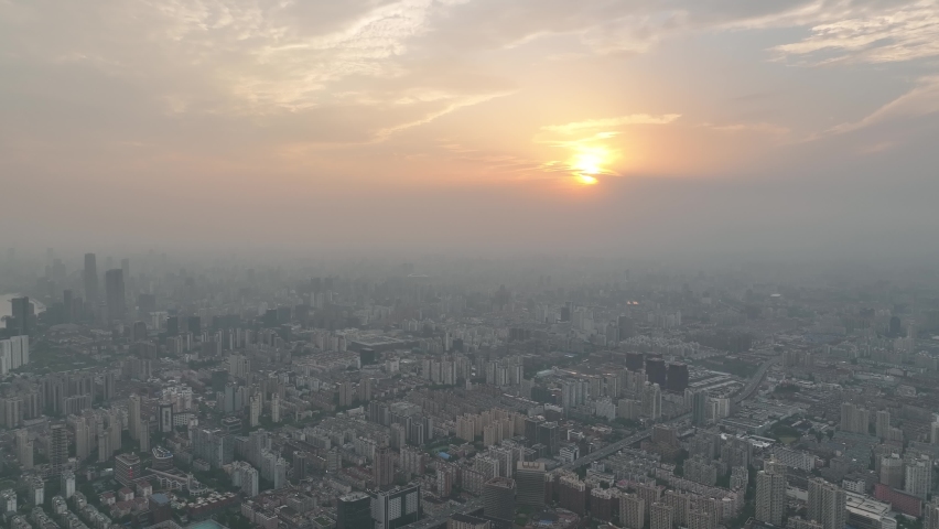 Drone aerial view of Buildings and city in the beautiful sunset. Sunset glow and the downtown city of Shanghai China, cityscape of asian city. Business, travel and life style concept b-roll footage.