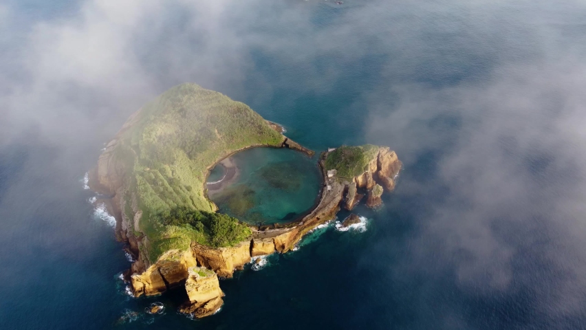 Azores. Drone flying over Vila Franca do Campo volcanic island in atlantic ocean, San Miguel, Azores, Portugal. Overhead shot of volcanic islet washing by atlantic ocean water, 4k footage Royalty-Free Stock Footage #1091432269