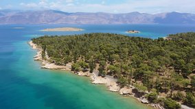Aerial drone video of famous seaside area and forest of Kentri in picturesque village and port of Galaxidi, Fokida, Greece