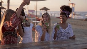 Young beautiful women drinking and dancing at cocktail party on the beach, female friends having fun at chiringuito during vacation, holiday activities, slow motion clip - Powered by Shutterstock - Get 15% off with code: PIKWIZARD15
