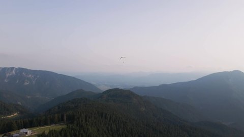 Mountain Range in Morning Mist with Paraglider Above Valley, Sky Background
