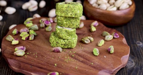 fresh Turkish delight with crushed pistachios and chocolate, fresh Turkish delight with green pistachios falls from a push with your hand