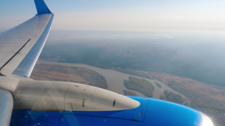 View of the area from the window of the aircraft. Aircraft engine and wing from the porthole